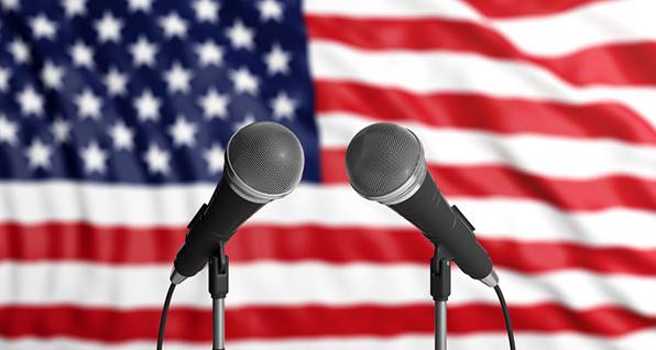 Microphones in front of American flag