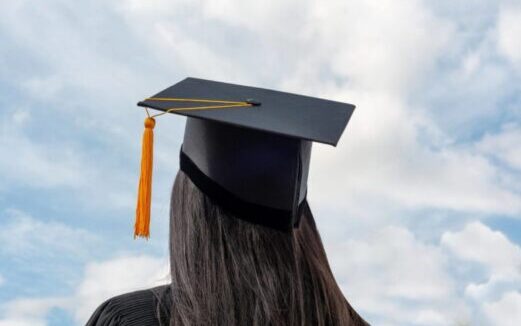 Woman facing away wearing a graduate cap