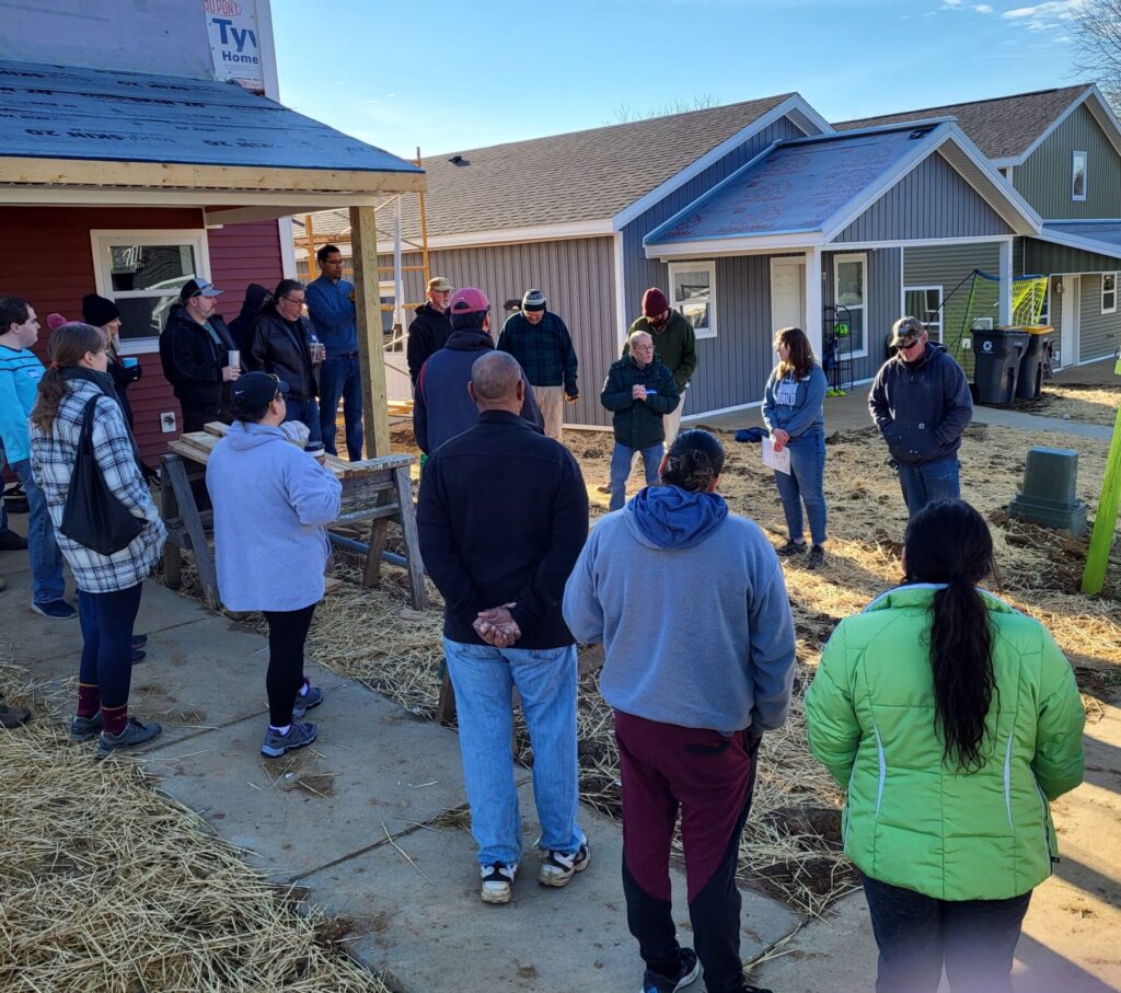 Volunteers gather at start of Habitat for Humanity-Braver Angels construction project.