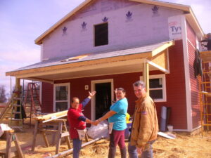 Indiana State Treasurer Daniel Elliott, with future homeowners Juana and Laura